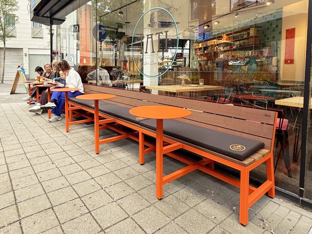 Roodoranje terrasbanken van staal en IPE - Kussens met geborduurd logo - Maatwerk terrasbanken voor horeca - Robuust Maatwerk uit Limburg Nederland - Roodoranje terrasbanken voor P'tit Tati